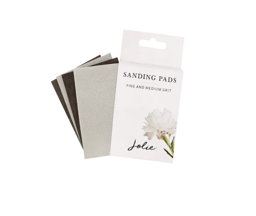 Package of fine and medium grit Jolie sanding pads on white background 